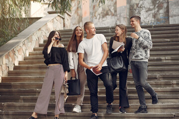 Obraz premium Students in a park. Girls in a park. Friends with a notebooks.