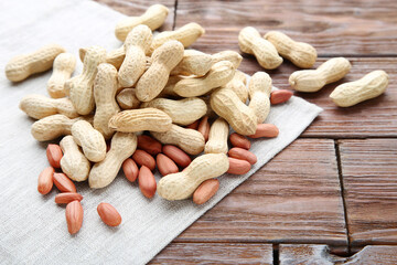 Peanuts with napkin on brown wooden table