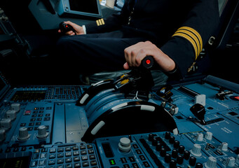 Captain hand accelerating on the throttle in commercial airplane