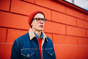 Caucasian confident man in autumn jeans jacket and cap. Millennial 25 years old male