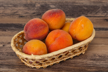 Peach heap in the wooden basket