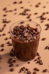 acrylic cup with brigadeiro and chocolate sprinkles on brown background