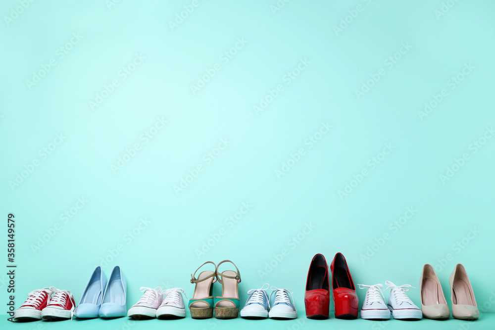 Wall mural Different female shoes on mint background