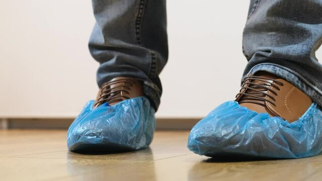 Man goes in shoe covers to the doctor