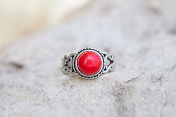 White metal silver ornamental ring with red coral mineral stone
