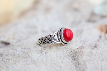 White metal silver ornamental ring with red coral mineral stone