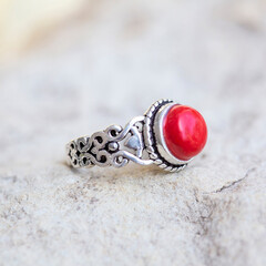 White metal silver ornamental ring with red coral mineral stone