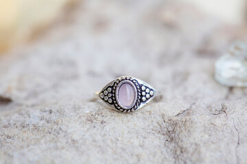 White metal silver ornamental ring with red rose quartz mineral stone