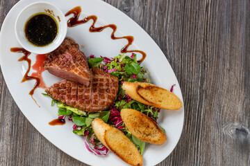 grilled duck breast with honey sauce and salad