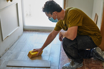Worker wiping the floor with a sponge