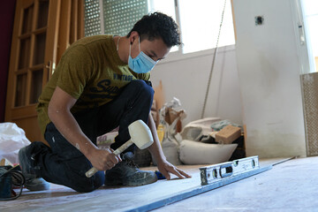 Bricklayer tiling a room