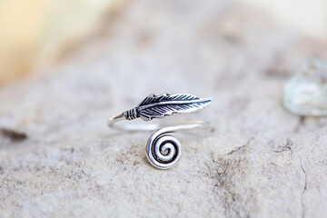 White metal silver ornamental ring with feather shape