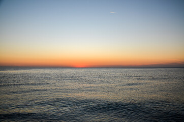 Fototapeta na wymiar Beautiful orange sunrise on the Mediterranean Sea shore at Olympos coast, Cirali village, Turkey