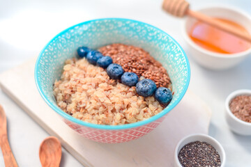 High protein healthy breakfast, buckwheat porridge with blueberries and honey