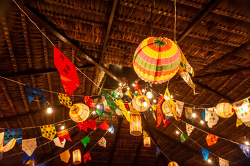 Traditional flags and lanterns of June festivities in northeastern Brazil. Background colorful. © Cacio Murilo