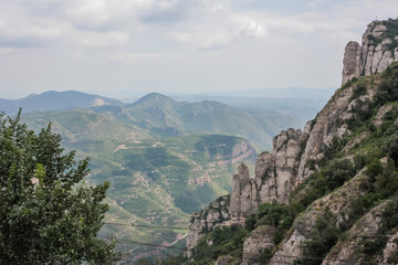 Fototapeta na wymiar Spain. Catalonia - 30 AUGUST 2014. View from the top of the Montserrat Mountains and the Montserrat Monastery in the lower part