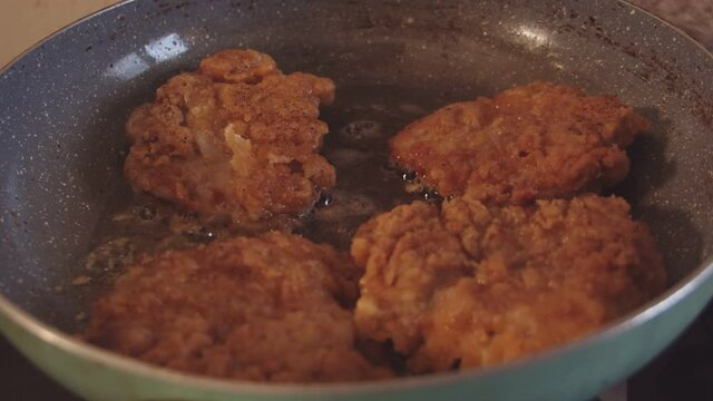 Frying chicken breasts in a pan