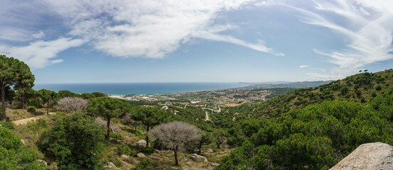 Panoramic view of Barcelona and the Maresme. Made from Premia de Dalt. Sunny day with some decorative clouds.