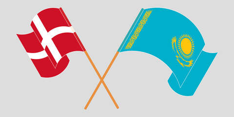 Crossed and waving flags of Kazakhstan and Denmark
