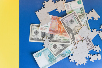 Missing jigsaw puzzle pieces on money dollar ob blue background, Business solution concept ,key for success.Conceptual of never ending conflicts between US and Russia on trade.economic crisis