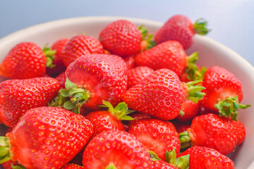 Strawberry closeup. Macro image of fresh strawberries on dark background