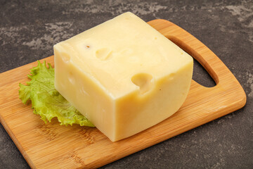 Emmental cheese over wooden board