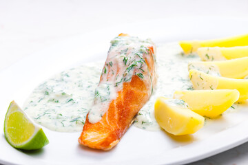 baked salmon with creamy dill sauce and potatoes