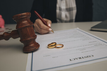 Woman signing marriage contract, closeup.