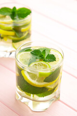 Cold fresh lemonade drink on a pink background