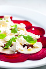 fresh beetroot and apple salad with fresh goat cheese and arugula