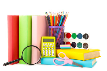 Multi coloured school books and stationery isolated on white background