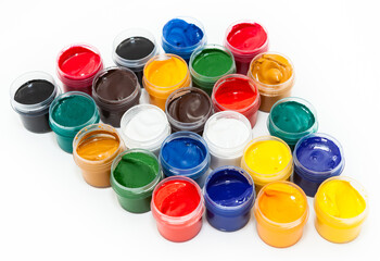 A lot of colorful paints in plastic boxes for drawing, a white background