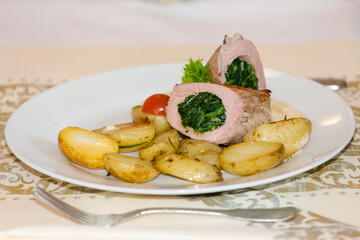 meat roll filled with spinach and roasted potatoes