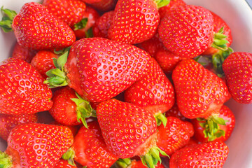 Strawberry closeup. Macro image of fresh strawberries on dark background