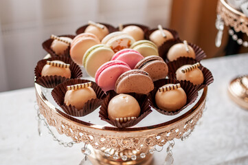 Candy bar with sweet macaroon cakes at a wedding buffet
