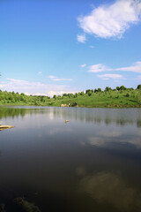 Beautiful river in the highlands in summer. Lake in an ecologically clean park reserve on a background of hills. A pretty landscape in the spring. Stock photo for design