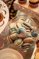 Candy bar with sweet macaroon cakes at a wedding buffet