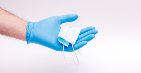 World Epidemic Danger. Protect face mask in hands, isolated on a white background. Human Epidemic Danger.