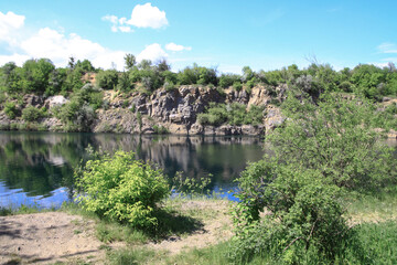 Beautiful river in the highlands in summer. Lake in an ecologically clean park reserve on a background of hills. A pretty landscape in the spring. Stock photo for design