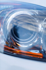 colorful headlights of white car after the rain at night on car parking