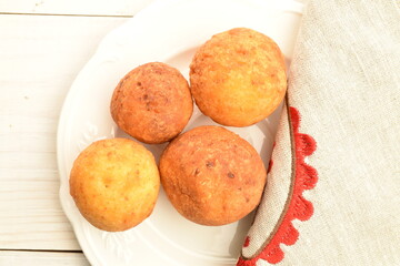 Fresh aromatic, cheese donuts, close-up, on a white ceramic plate.
