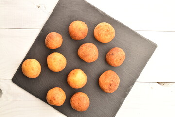 Fresh aromatic, cheese donuts, close-up, on a slate board.
