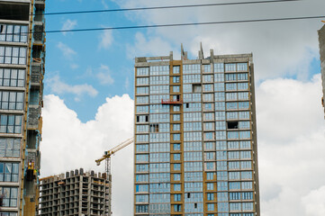 Construction site background. Hoisting cranes and new multi-storey buildings. I.ndustrial...