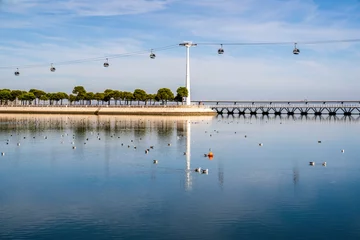 Cercles muraux Pont Vasco da Gama Lisbon, Portugal - October 7 The Cable Car and Vasco da Gama Bridge in Lisbon on Obctober 7, 2019. The Cable Car provides an air trip over the whole of the Park of Nations. Portugal, Europe.