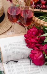 Mood reading a picnic book under a glass of red wine