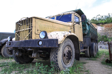 Obraz premium Old truck in very poor condition. A car stands in nature like abandoned metal rubbish. Stock photo background for design.