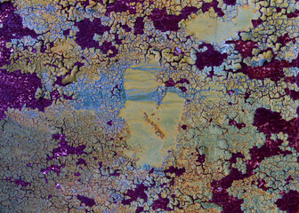 Textured multicoloured painted bubbly cracked rusty aged metal background.