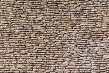 antique wall of rough brown stone