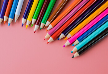 Colored pencils on red background for art and school