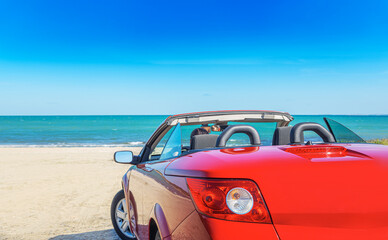 Fototapeta na wymiar Red car on the beach. Vacation and freedom concept.